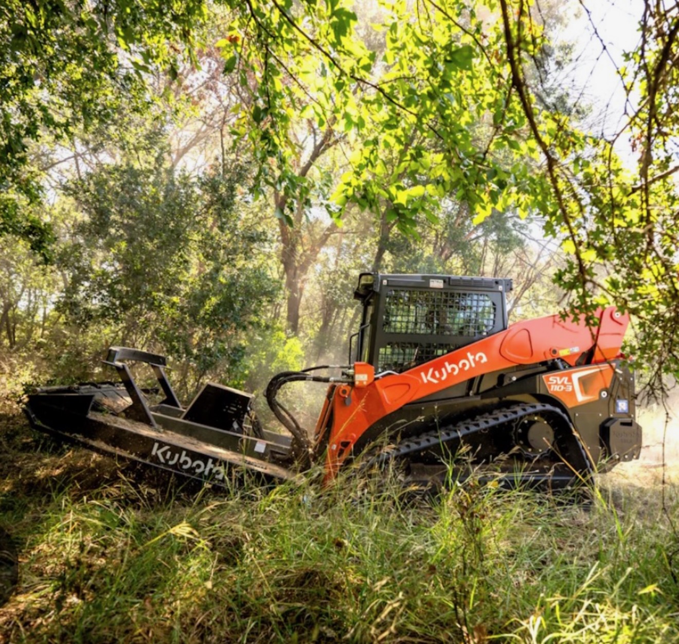 Skid steer clearing brush at TLowe Outfitters